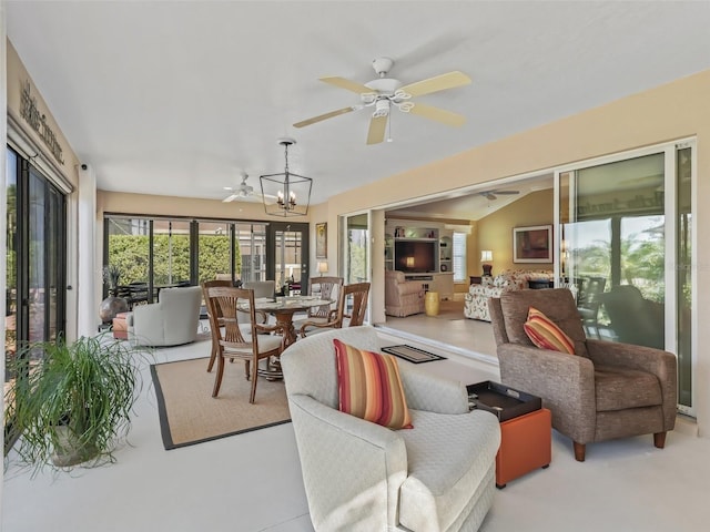 sunroom with lofted ceiling and ceiling fan with notable chandelier