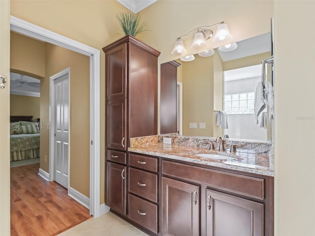 bathroom with vanity, crown molding, and tile patterned floors