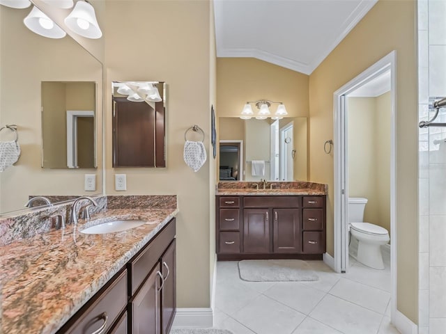 bathroom featuring lofted ceiling, crown molding, vanity, tile patterned floors, and toilet