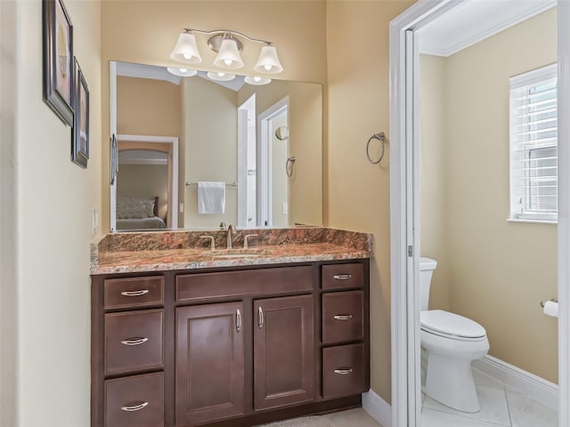 bathroom featuring tile patterned floors, vanity, and toilet