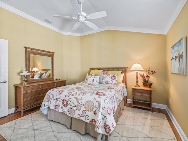 bedroom with ceiling fan, ornamental molding, vaulted ceiling, and light wood-type flooring