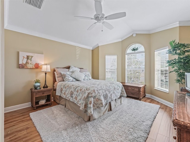 bedroom with crown molding, ceiling fan, lofted ceiling, and light hardwood / wood-style floors