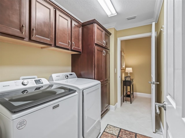 washroom featuring separate washer and dryer, cabinets, and a textured ceiling