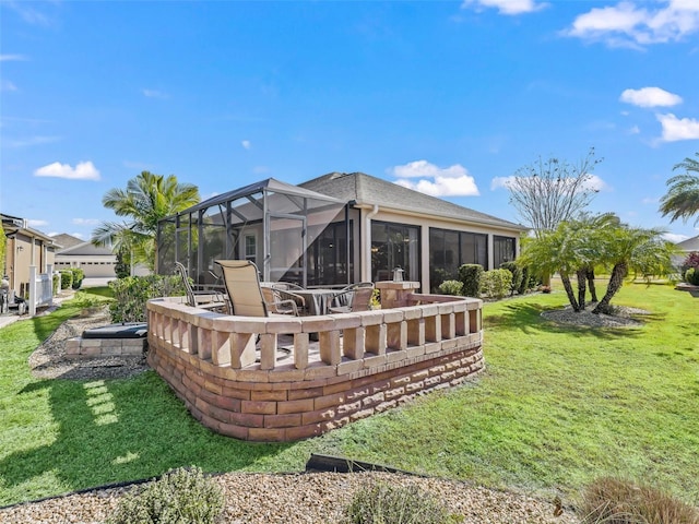 rear view of house featuring a yard and a lanai