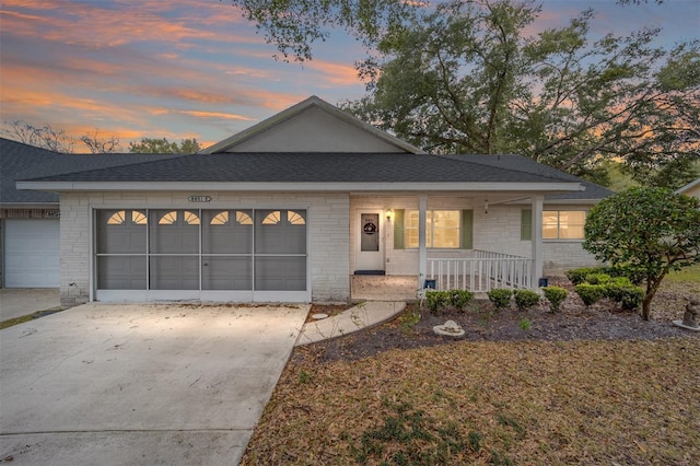 view of front of house featuring covered porch and a garage