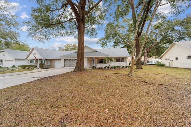 ranch-style home with a garage, a front yard, and covered porch