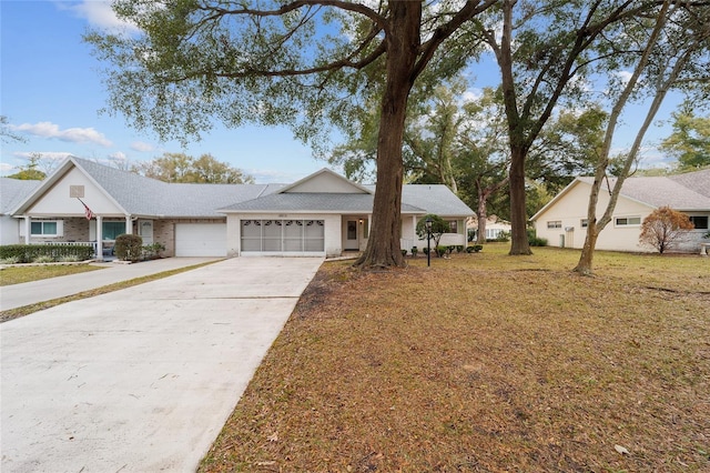 ranch-style house with a garage and a front lawn