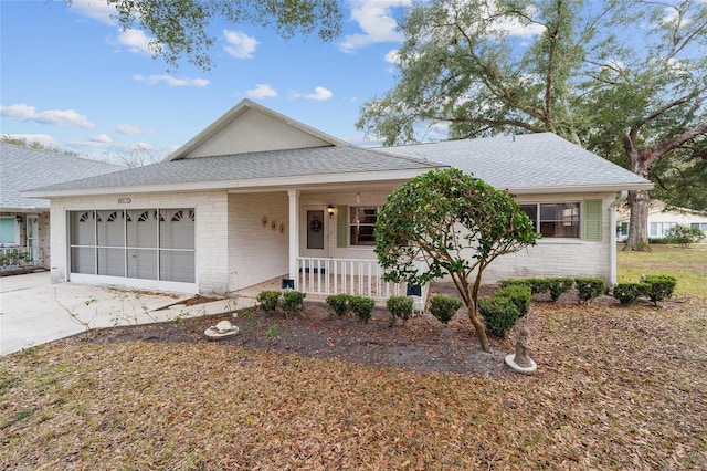 ranch-style home with a porch and a garage