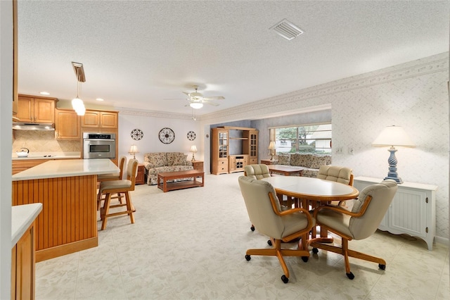 dining space with radiator heating unit, a textured ceiling, and ceiling fan