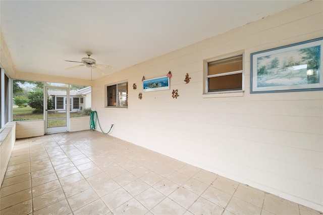 unfurnished sunroom with ceiling fan