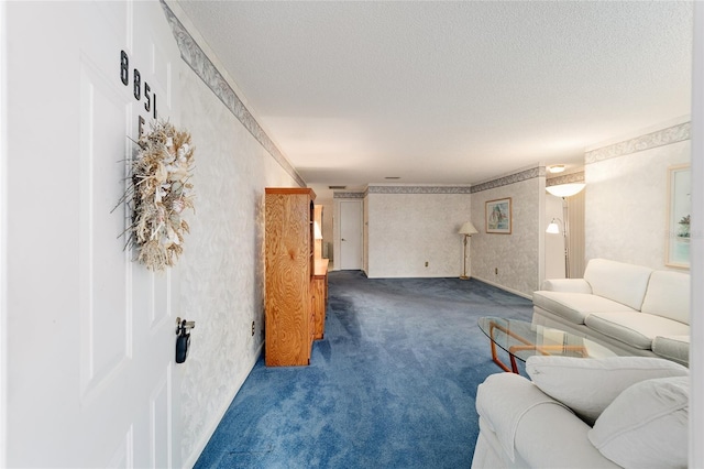 living room featuring dark colored carpet and a textured ceiling