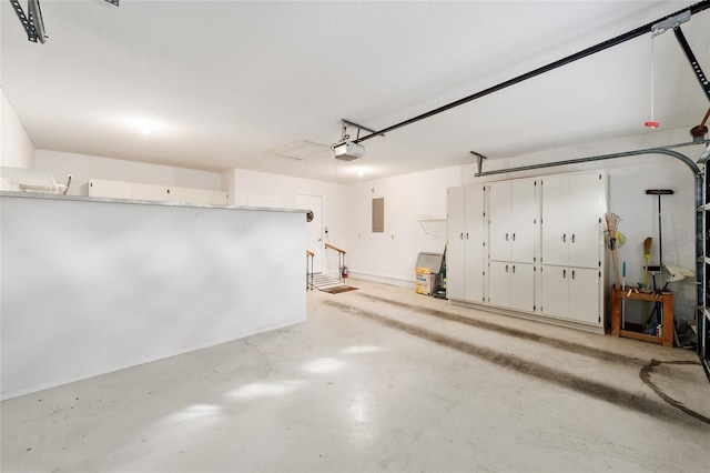 garage with electric panel and a garage door opener