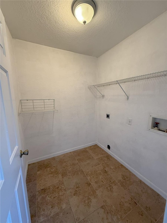 laundry area with washer hookup, hookup for an electric dryer, and a textured ceiling