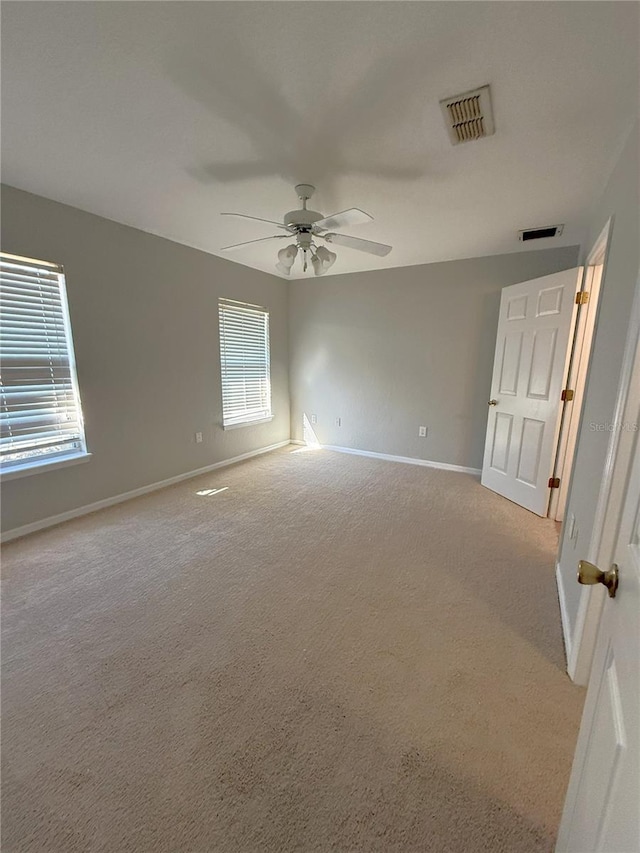 carpeted empty room featuring ceiling fan