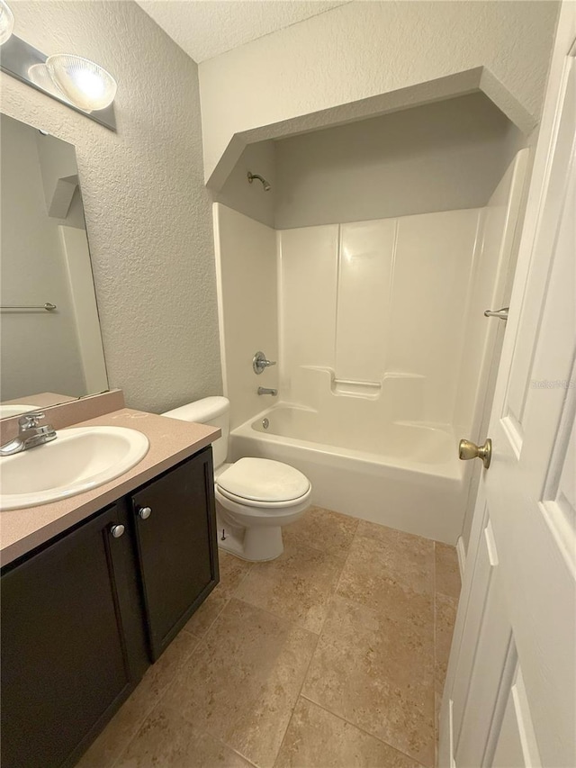 full bathroom featuring vanity, toilet, a textured ceiling, and shower / tub combination