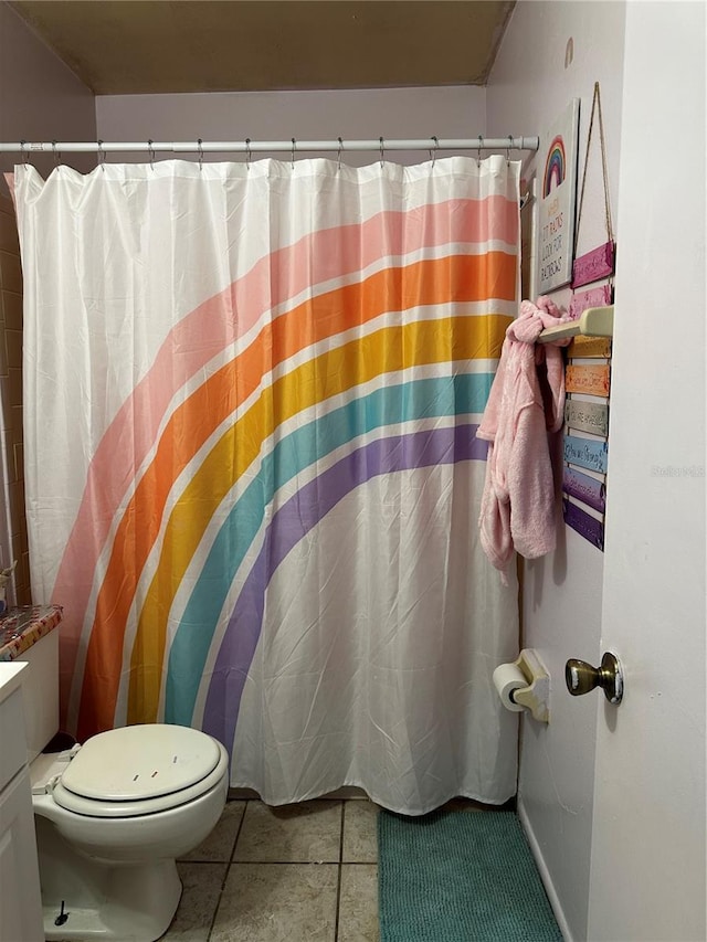 bathroom featuring tile patterned floors, toilet, curtained shower, and vanity