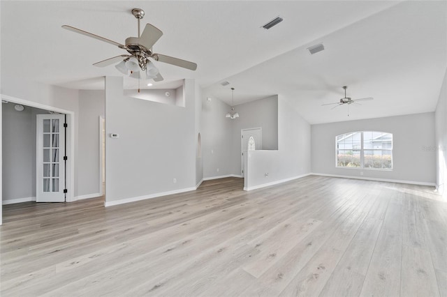 unfurnished living room featuring light hardwood / wood-style floors, ceiling fan with notable chandelier, and lofted ceiling