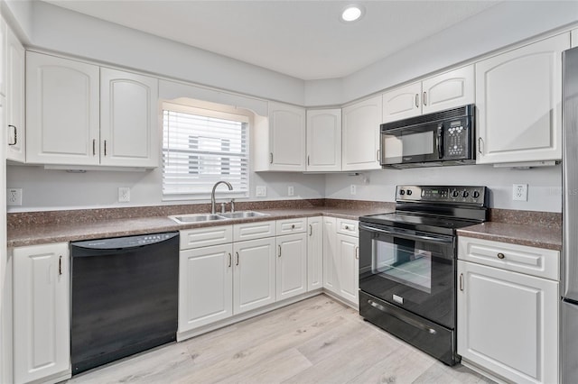 kitchen featuring black appliances and white cabinets