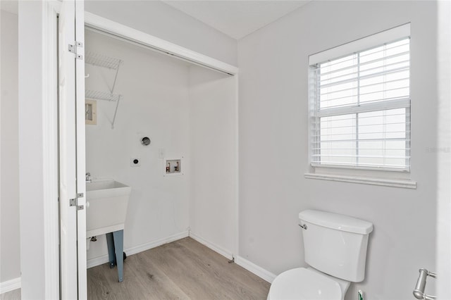 bathroom featuring hardwood / wood-style flooring and toilet