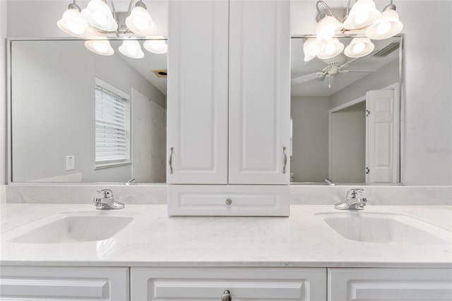 bathroom featuring vanity and ceiling fan with notable chandelier