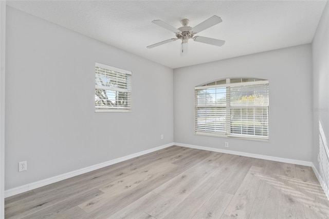 unfurnished room featuring light hardwood / wood-style floors, a textured ceiling, and ceiling fan