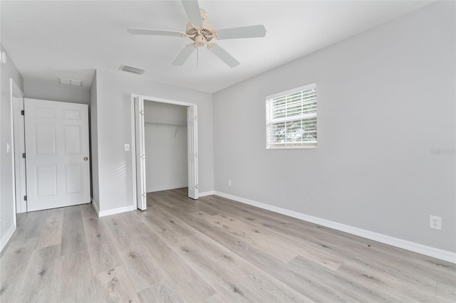 unfurnished bedroom featuring light hardwood / wood-style floors, a closet, and ceiling fan