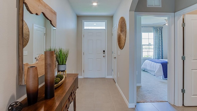 doorway to outside featuring light carpet