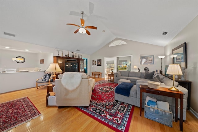 living area featuring visible vents and wood finished floors