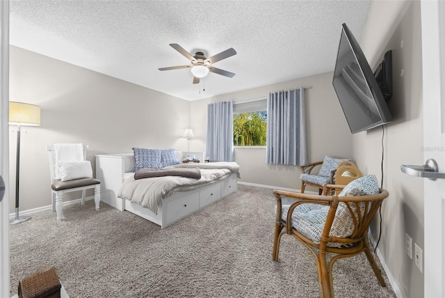 carpeted bedroom with a ceiling fan, a textured ceiling, and baseboards