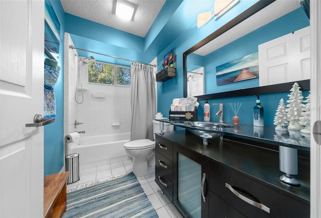 full bathroom featuring toilet, shower / tub combo, vanity, a textured ceiling, and tile patterned floors