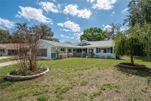 ranch-style home with a front yard, covered porch, and driveway