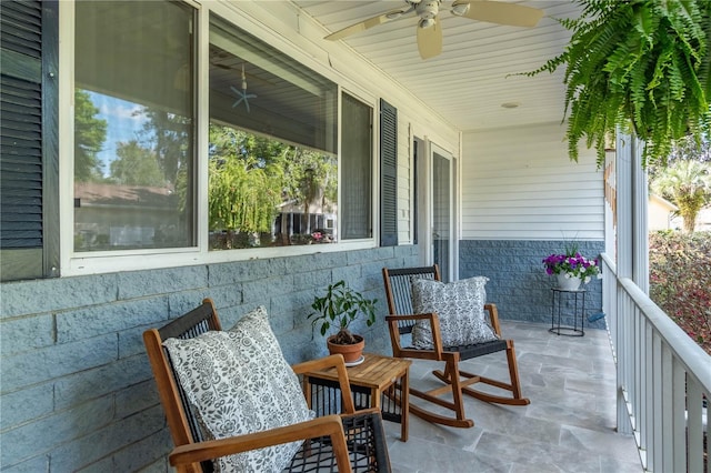 balcony with a porch and a ceiling fan