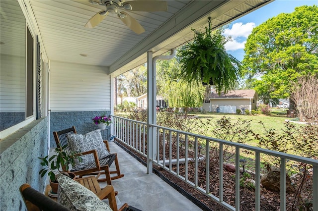 balcony with a porch and ceiling fan