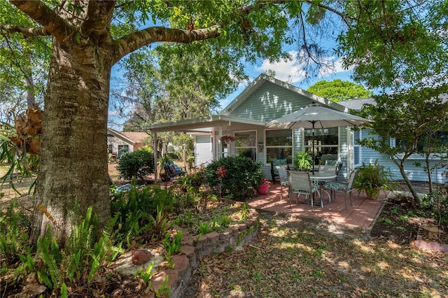 rear view of property featuring a patio area