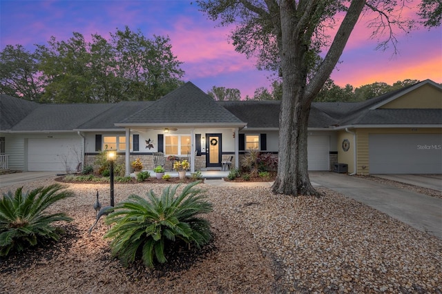 single story home with a garage and covered porch