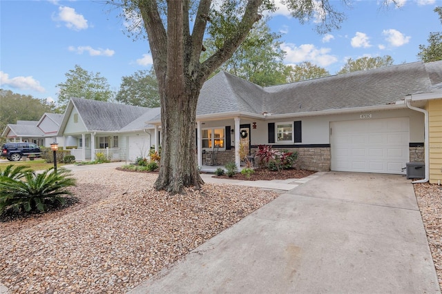 single story home featuring a garage and a porch