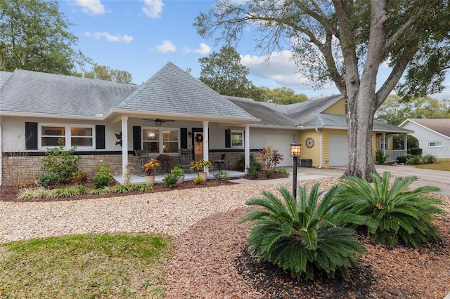 view of front of home with ceiling fan, a porch, and a garage