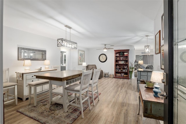 dining space featuring ceiling fan and light wood-type flooring