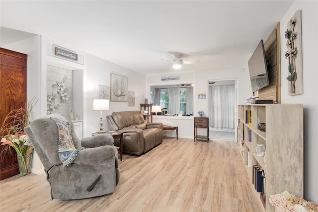 living room featuring light hardwood / wood-style flooring and ceiling fan