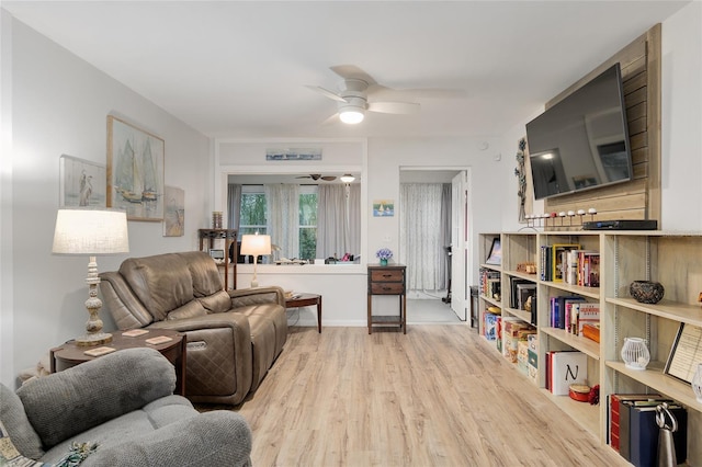 living room with light wood-type flooring and ceiling fan