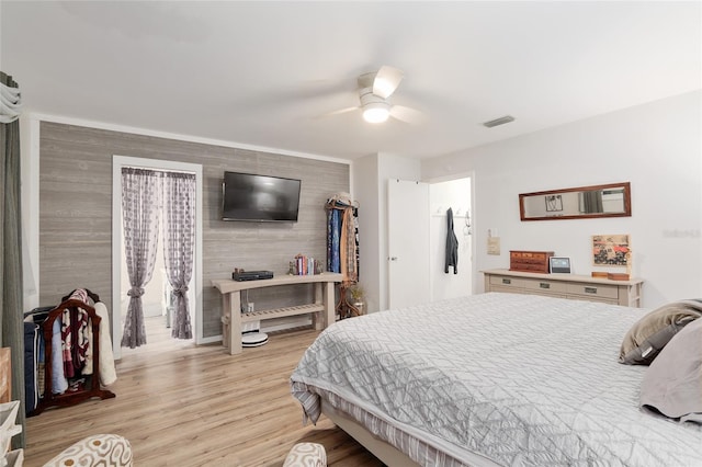 bedroom with light hardwood / wood-style floors and ceiling fan