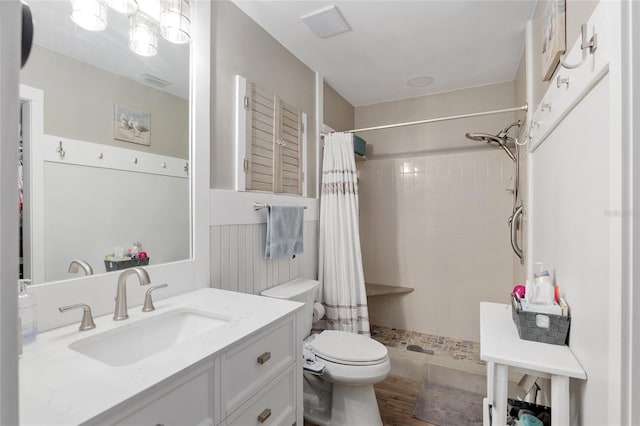 bathroom featuring hardwood / wood-style flooring, vanity, a shower with shower curtain, and toilet