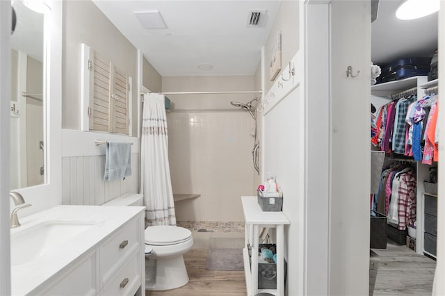 bathroom with hardwood / wood-style floors, vanity, and a shower with shower curtain