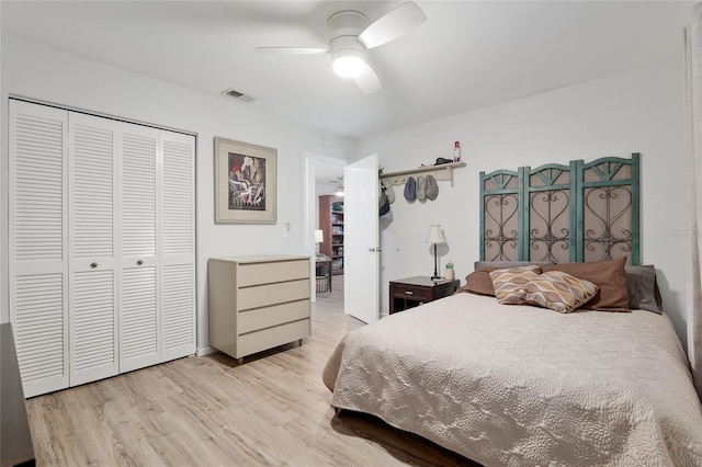 bedroom with light wood-type flooring, a closet, and ceiling fan