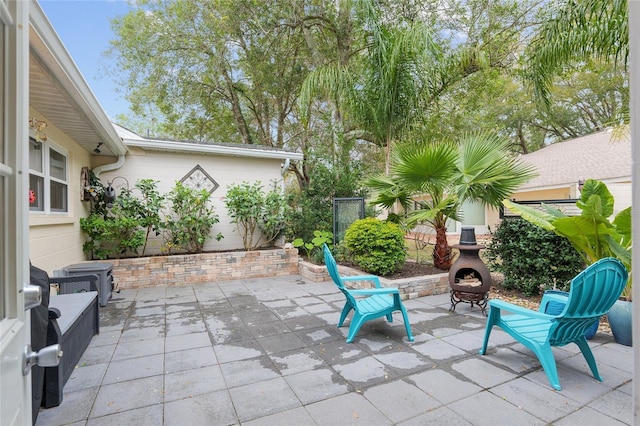 view of patio featuring an outdoor stone fireplace