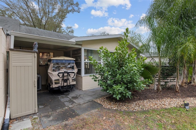 view of patio with central air condition unit and a carport