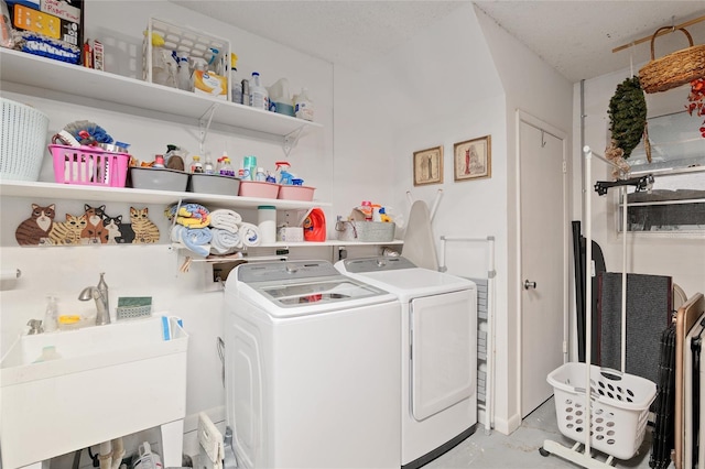 washroom with sink and washing machine and clothes dryer