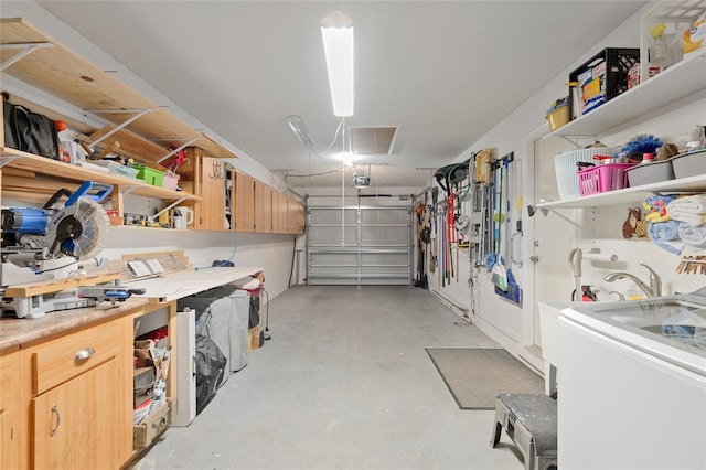 garage featuring a garage door opener and washer / dryer