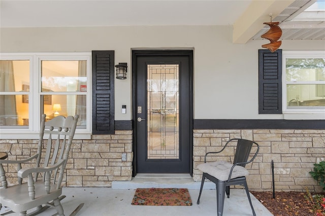 8723 SW 93rd Ln Unit C, Ocala, FL 34481 - doorway to property featuring stucco siding, stone siding, and covered porch