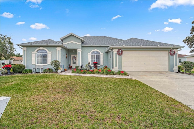 single story home featuring a garage and a front lawn